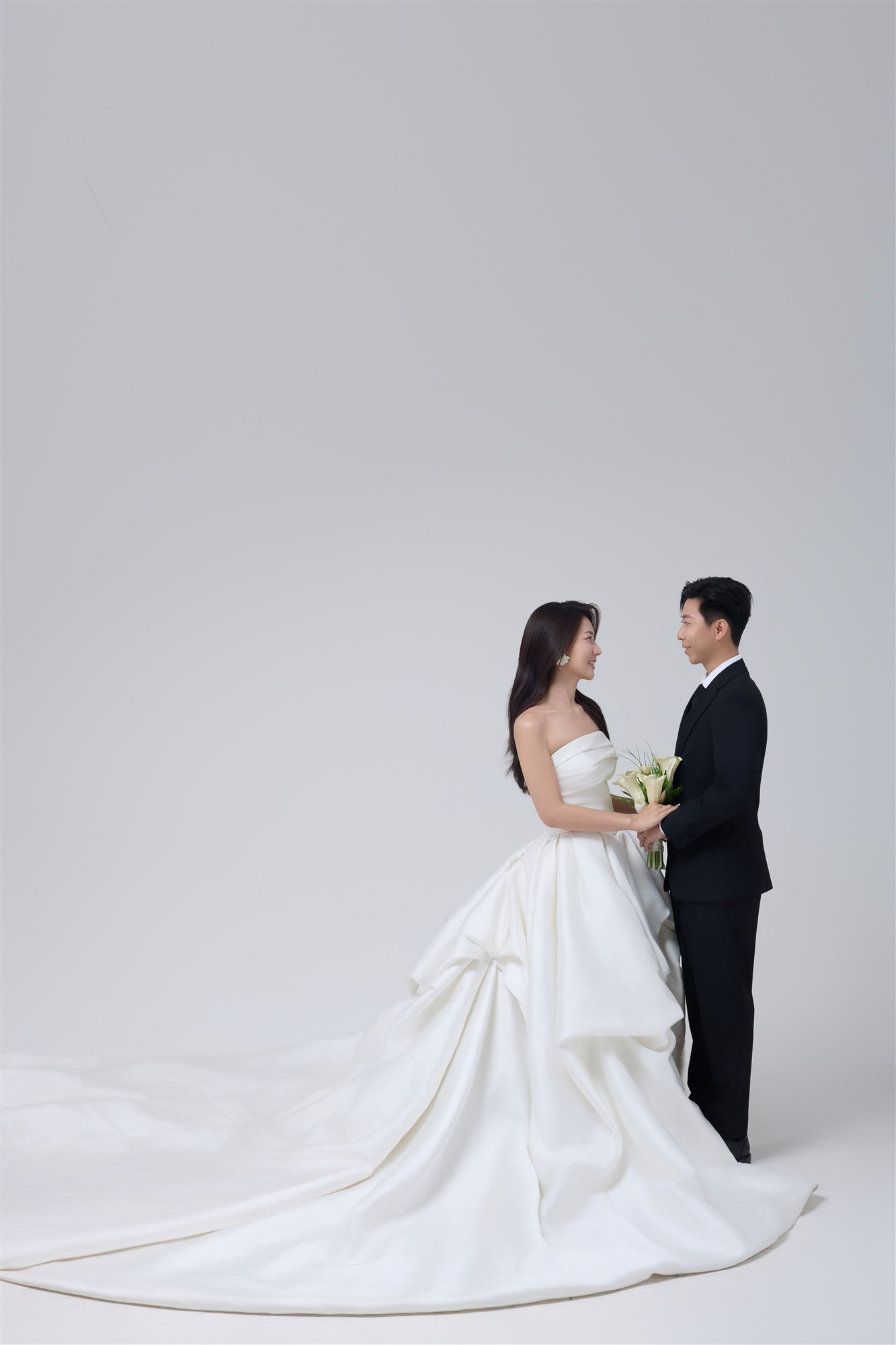 Zaw and Shwan standing together in formal wedding attire